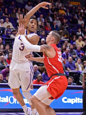 LSU guard Tremont Waters (3) passes over Houston guard Rob Gray (32), during an NCAA college basketball game Wednesday, Dec. 13, 2017, in Baton Rouge, La. (Hilary Scheinuk/The Advocate via AP)