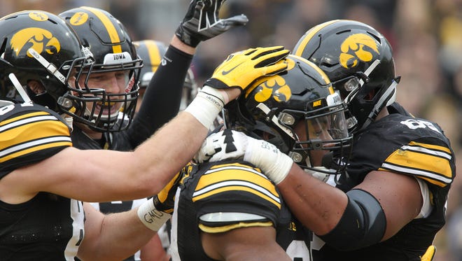 Teammates surround Iowa running back LeShun Daniels, Jr. after his touchdown during their game against Maryland at Kinnick Stadium on Saturday, Oct. 31, 2015.