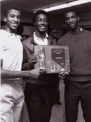 Dion Brown, center, shows off Wolfpack Classic championship