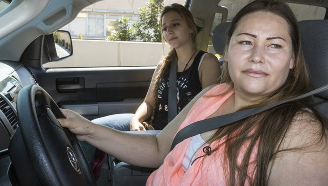 Immigrant Bertha Diaz, originally from Jalisco, Mexico, right, drives with her daughter Viviana Diaz, 17, without a California driving license, after attending a news conference at Coalition for Humane Immigrant Rights of Los Angeles in Los Angeles  on Sept. 13, 2013. A new California law will allow her to obtain a legal license.