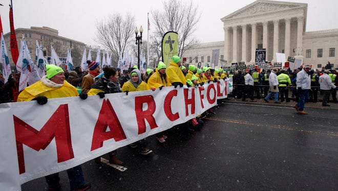 In this Jan. 22  photo, marchers carry a banner during the March for Life 2016, in front of the U.S. Supreme Court in Washington, during the annual rally on the anniversary of 1973 'Roe v. Wade' U.S. Supreme Court decision legalizing abortion.