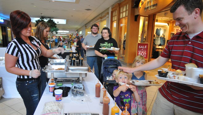 Fricker's employees serve samples to diners during the Taste of Wayne County at Richmond Square Mall.