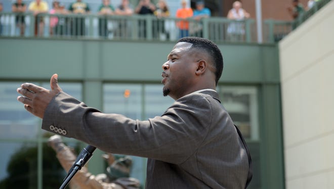LeRoy Butler, credited with originating the Lambeau Leap,  talks about the fans' love for the Packers during the unveiling of the Lambeau Leap sculpture on Harlan Plaza at Lambeau Field Friday, August 1, 2014.  Jim Matthews/Press-Gazette Media