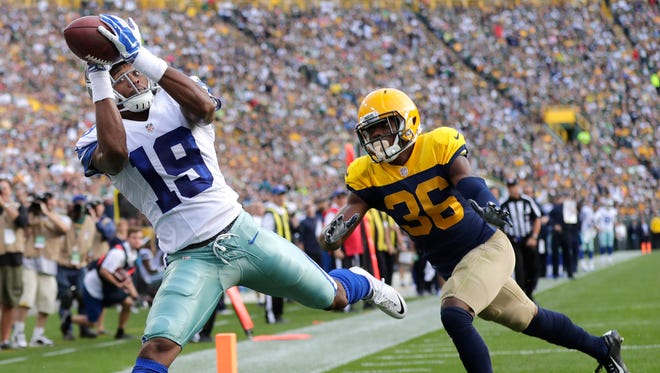 Dallas Cowboys receiver Brice Butler catches a second quarter touchdown pass in front of Green Bay Packers cornerback LaDarius Gunter.