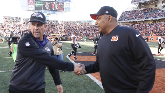 Bengals head coach Marvin Lewis (right) and Ravens head coach John Harbaugh shake hands after Sunday's win by the Bengals.
