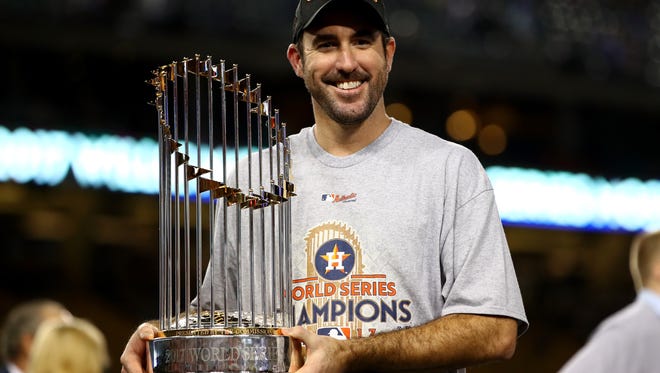 Astros pitcher Justin Verlander holds the Commissioner's Trophy after defeating the Los Angeles Dodgers, 5-1, in Game 7 to win the 2017 World Series at Dodger Stadium on November 1, 2017 in Los Angeles.