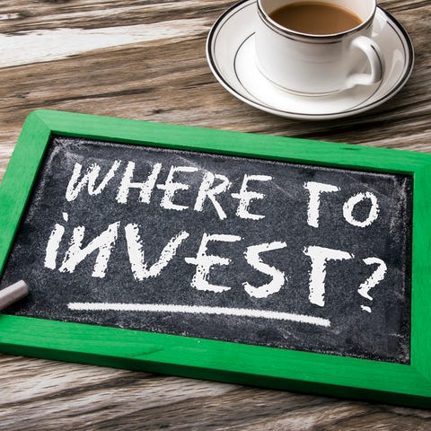 Chalkboard on a table with where to invest written