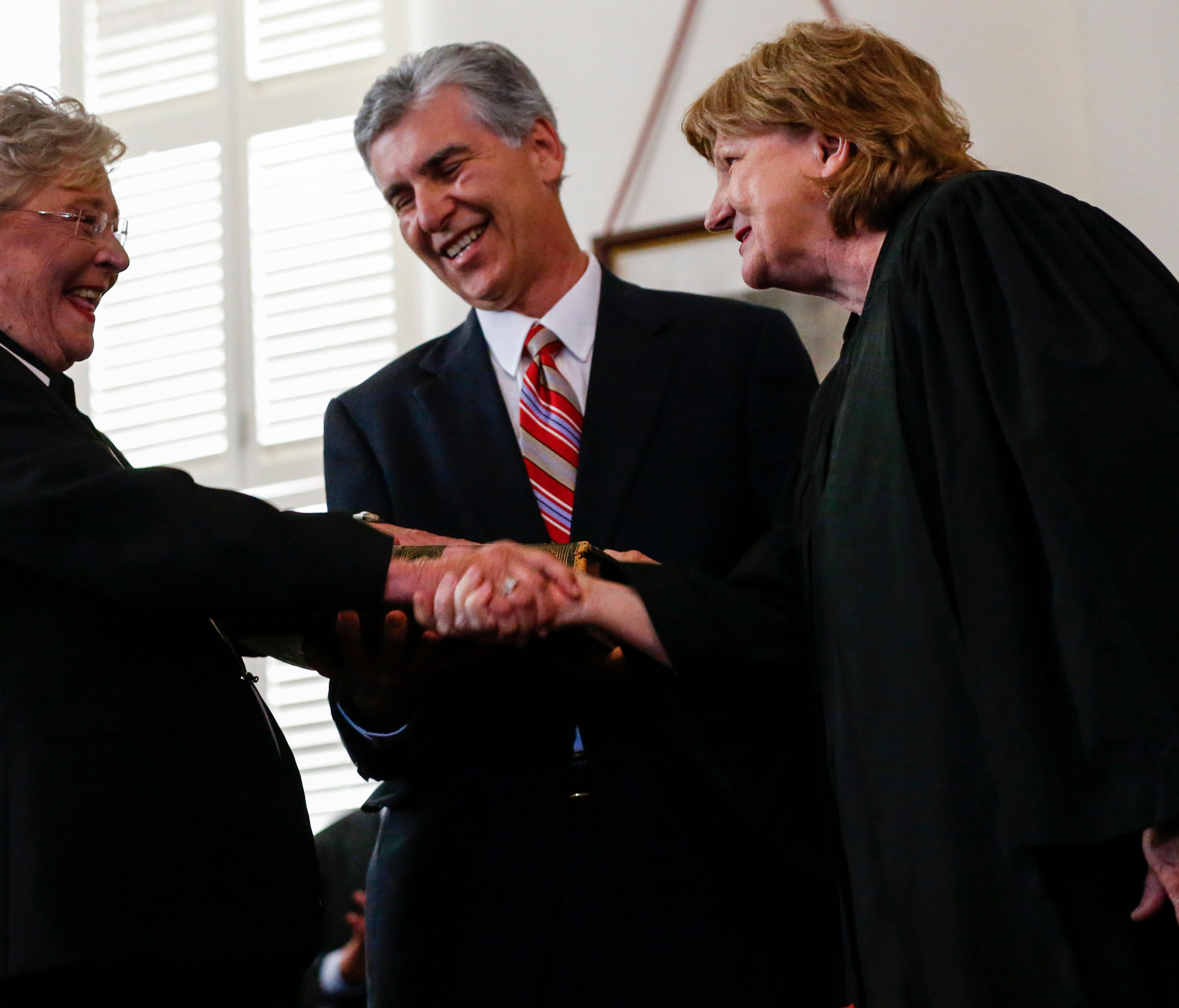 Acting Chief Justice, Lyn Stuart (right), congratulates Kay Ivey (left) after she is sworn in as Governor of Alabama.