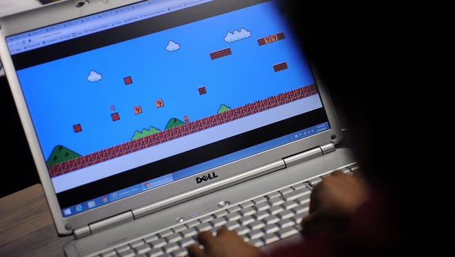 Students work on coding during a gaming bootcamp on Thursday, August 13, 2015.
