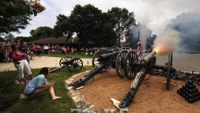 Morgan Sampson pulls a lanyard to fire a 12-pound cannon in the front yard of Frank Markel's house, 4004 Shady Lane, on July 4, 2016, in Greenfield.