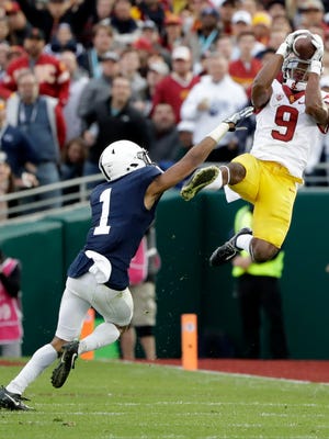Southern California wide receiver JuJu Smith-Schuster catches a pass under pressure from Penn State cornerback Christian Campbell during the first half of the Rose Bowl NCAA college football game Monday, Jan. 2, 2017, in Pasadena, Calif. (AP Photo/Gregory Bull)