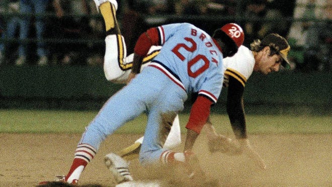 St. Louis Cardinals' Lou Brock steals second base standing up on Aug. 30, 1977, breaking Ty Cobb's major league record of 892 stolen bases.