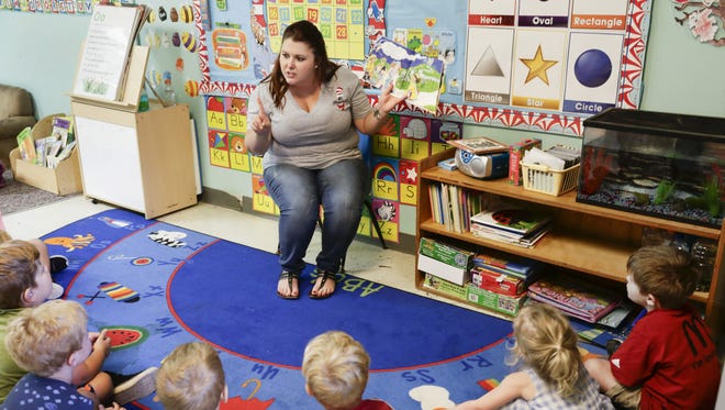 Chelsea LeBlanc reads a story to children at the Creative Learning Preschool  in Lafayette.