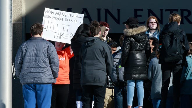 A student holds up a sign during the school walkout event Wednesday, March 14, 2018, at Wausau West High School in Wausau, Wis. T'xer Zhon Kha/USA TODAY NETWORK-Wisconsin