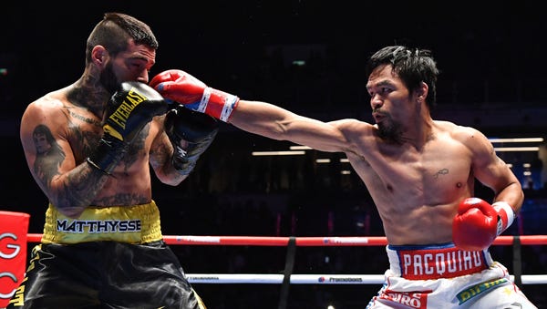 Manny Pacquiao (R) fights Lucas Matthysse during...