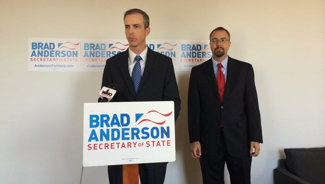 Secretary of State candidate Brad Anderson, at podium, offered three proposals for increasing ballot access for members of the military. Polk County Auditor Jamie Fitzgerald appeared with him.