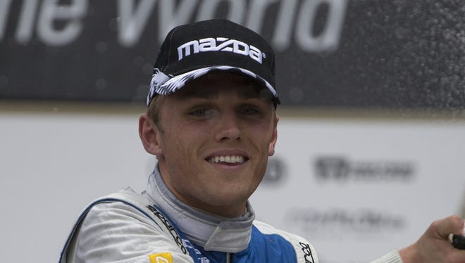 FILE -- Max Chilton celebrates his third place finish with sparkling wine after the Mazda Grand Prix of Indianapolis, Indy Lights Series, Indianapolis, Saturday, May 9, 2015.