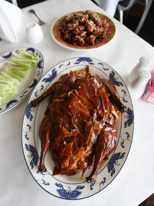Peking duck, bottom, and sesame chicken at Fortune Garden Restaurant in Nanuet.