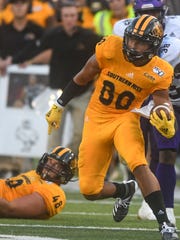 Southern Mississippi wide receiver Jordan Mitchell (80) runs upfield away from Alcorn State defensive end Creo Argue Jr. (38) in a college football game in August.