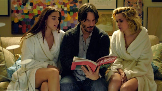 Ana de Armas (right) made an impression on her "Blonde" director with her role in 2015's "Knock Knock," starring Lorenza Izzo (left) and Keanu Reeves (center).