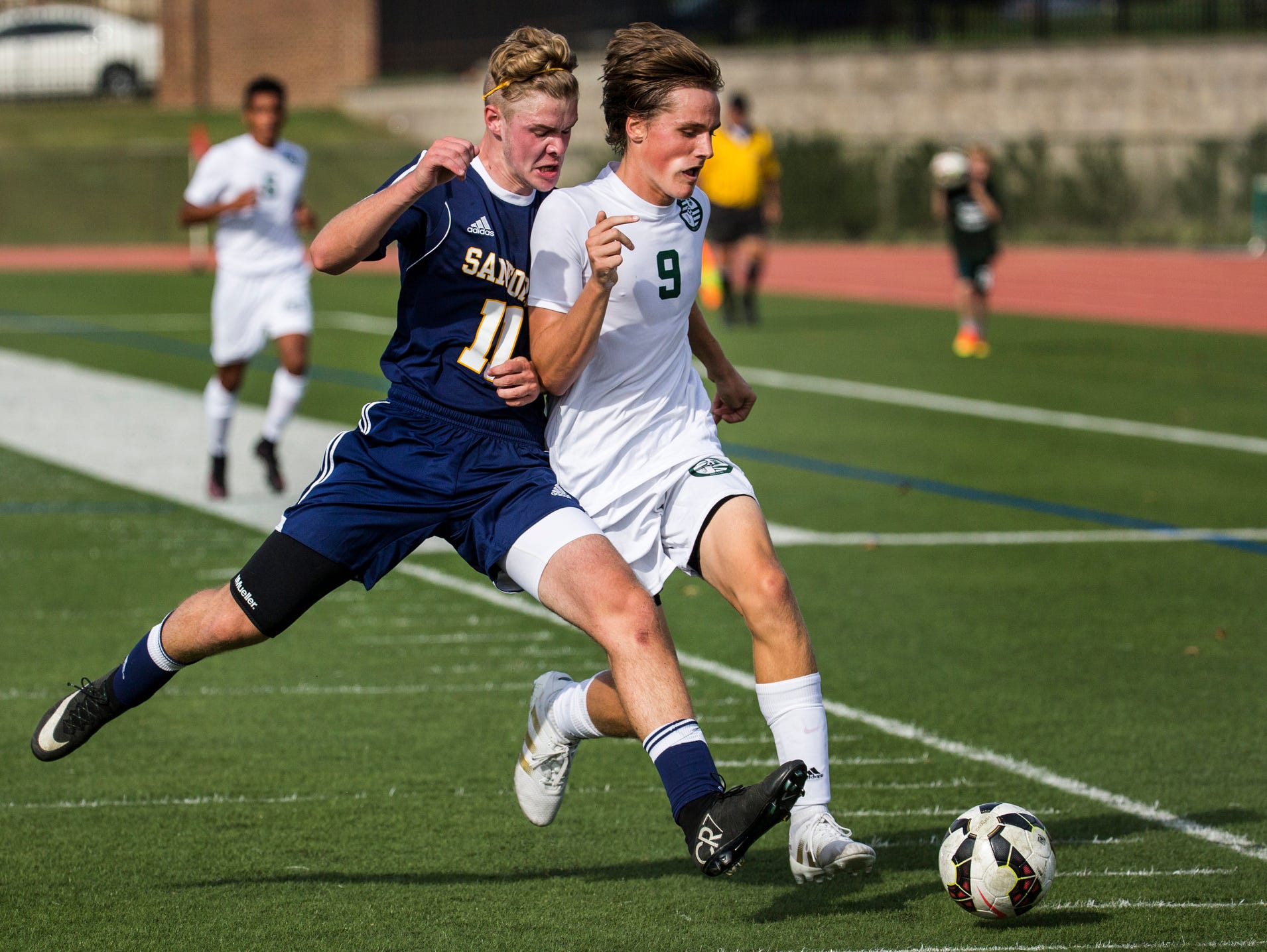Sanford's Robert Stafford (No. 11) and Tower Hill's Drew Manning (No. 9) fight for position on the ball in the first half of Tower Hill's 3-1 win over Sanford at Tower Hill School in Wilmington on Wednesday afternoon.