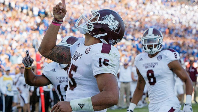 Mississippi State quarterback Dak Prescott celebrates after running for a touchdown during the second half of an NCAA college football game against Kentucky on Saturday at Commonwealth Stadium in Lexington, Ky.