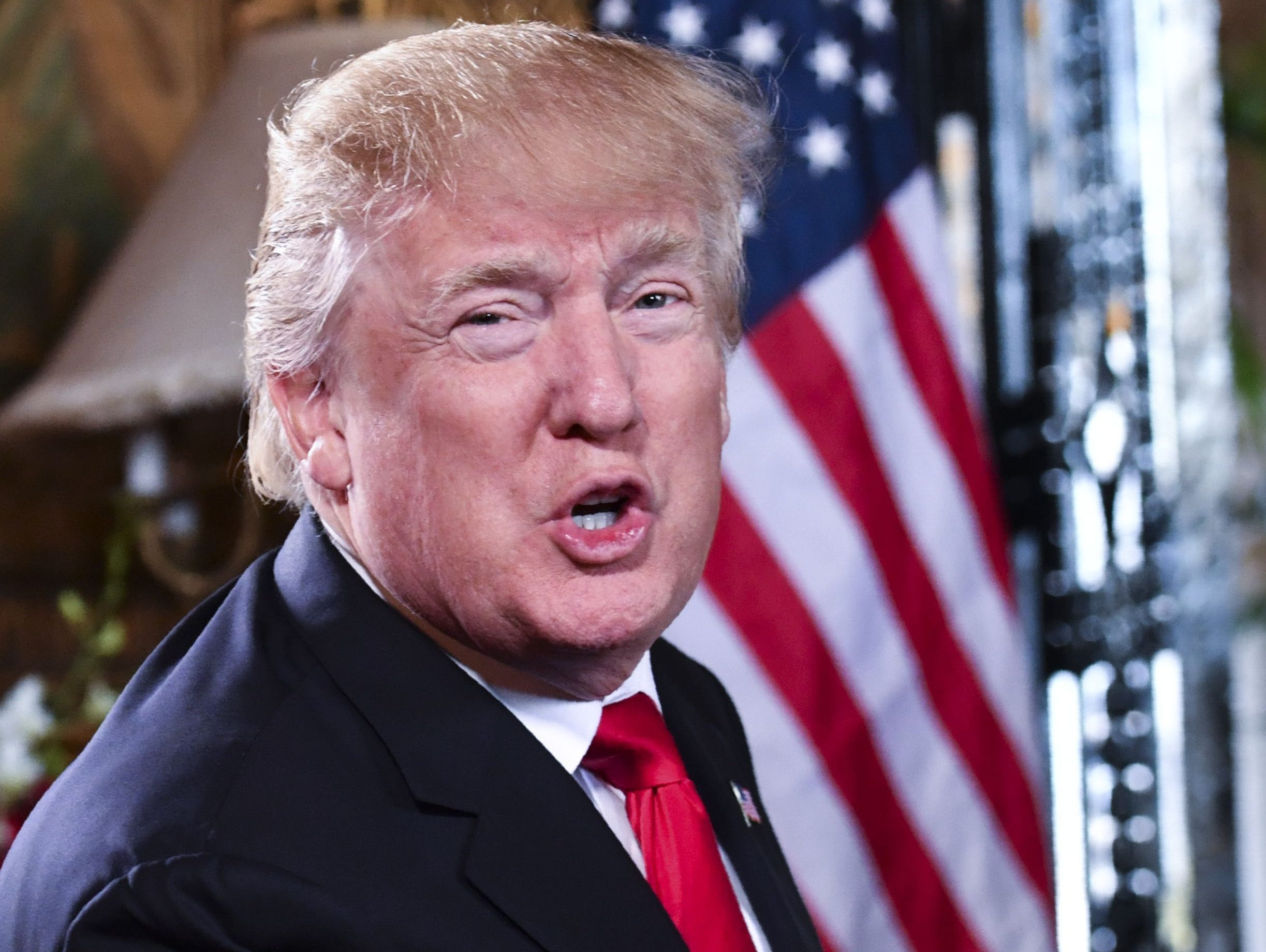 President Trump speaks to the media before participating in a video teleconference calls with military members in Palm Beach, Fla., Dec. 24, 2017.