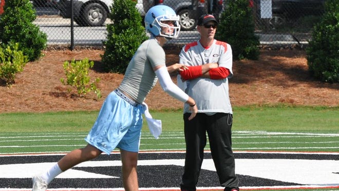 Collin Hill throws passes under the watchful eye of Mike Bobo, CSU's first-year coach, during a camp in Athens, Georgia. Bobo was the quarterbacks coach and offensive coordinator at Georgia at the time.