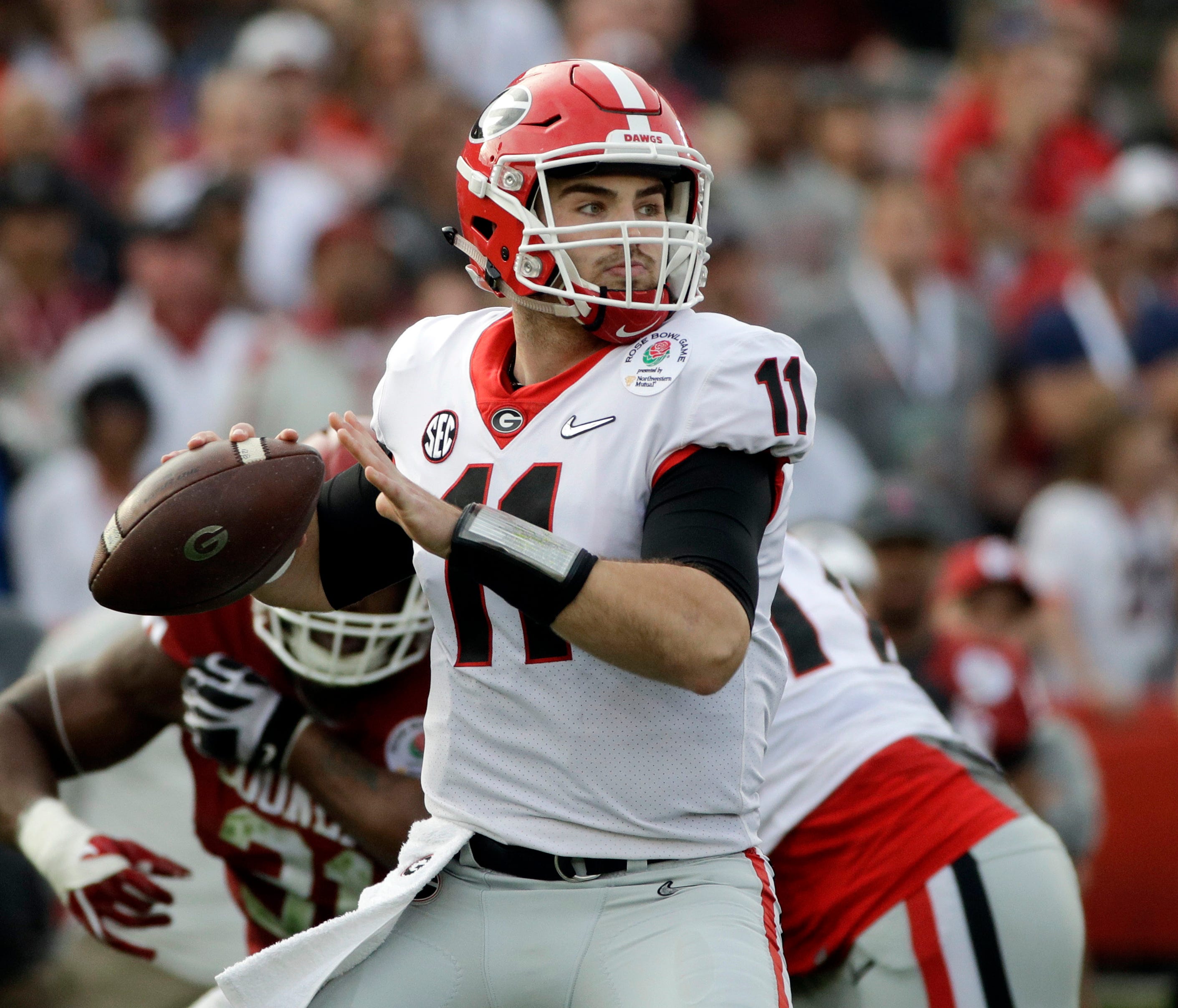 FILE- In this Monday, Jan. 1, 2018, file photo, Georgia quarterback Jake Fromm throws a pass during the Rose Bowl NCAA college football game against Oklahoma in Pasadena, Calif. Georgia plays Alabama in the Monday, Jan. 8, 2018, College Football nati