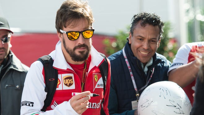 Nov 2, 2014; Austin, TX, USA; Ferrari driver Fernando Alonso (14) of Spain enters the paddock prior to the 2014 U.S. Grand Prix at Circuit of the Americas.
