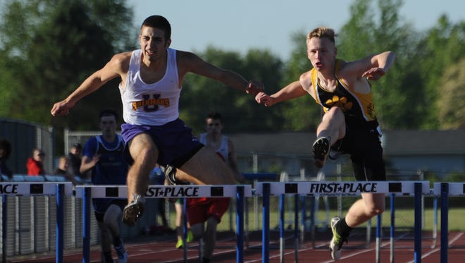Unioto's Ryan Callahan, left, and Paint Valley's Caden Summar compete in the boys 300-meter hurdles Monday during day one of the Scioto Valley Conference Track and Field Meet at Southeastern High School.