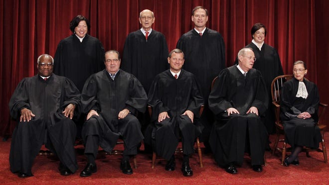 
U.S. Supreme Court justices pose for a group photo at the Supreme Court in Washington.
