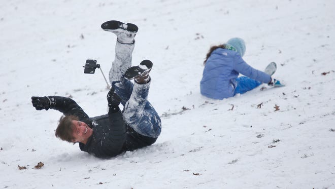 Kirk Thompson kept the phone's camera on himself as after falling off a sled he was riding with his daughter Nikki, at the Cresent Hill Golf Course. Jan. 20, 2016.