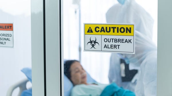 Patient and doctor behind a caution outbreak alert
