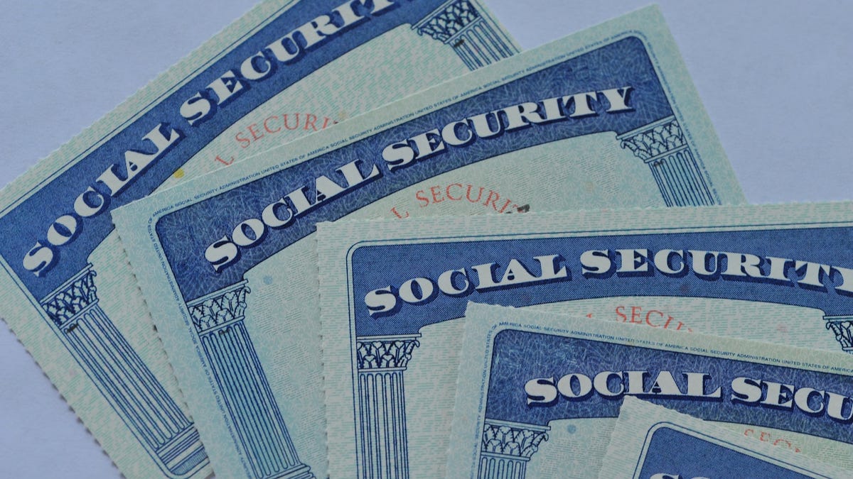 Loose stack of five Social Security cards lying one on top of the other