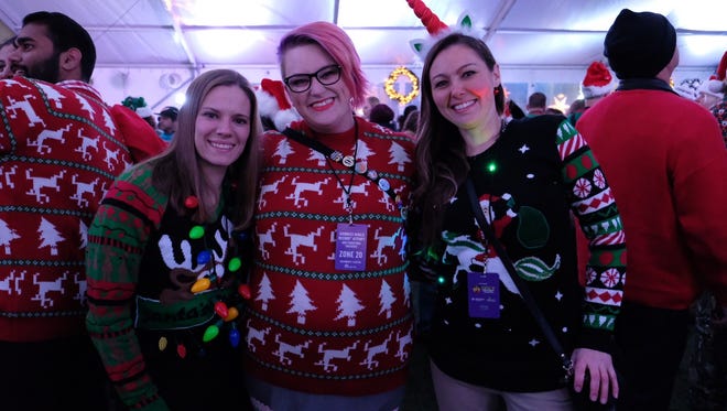 Alyssa Karlyle, 29, Nik Haller, 31, and Melissa Sawicki, 35, neighbors from Allen Park, celebrated their love for Christmas sweaters.