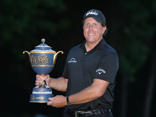 March 4: Phil Mickelson poses with the winner's trophy