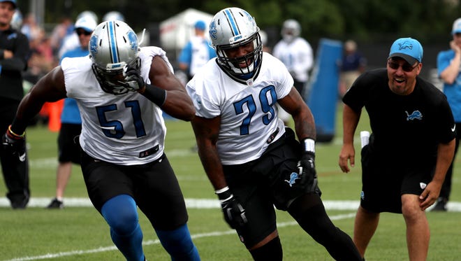 Detroit Lions #51 Brandon Copeland and #79 Quanterus Smith, both defensive ends do defensive drills during training camp at the Detroit Lions practice facility in Allen Park on Saturday, July 30, 2016.