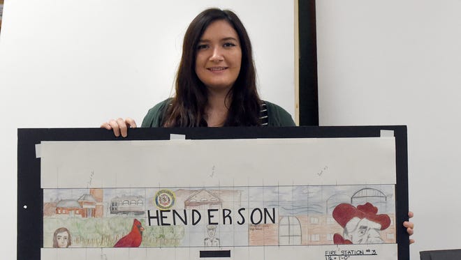 Henderson County High School senior Olivia Sadler reveals one of the drawings she worked on with Hadlie Comer at the school in Henderson Tuesday.  Students in Brian Ettensohn's art classes are working on completing two large murals out of aluminum panels, one of which will soon be installed in East End Park, and another at Fire Station 3. The murals are the result of a partnership between the city of Henderson and the high school.