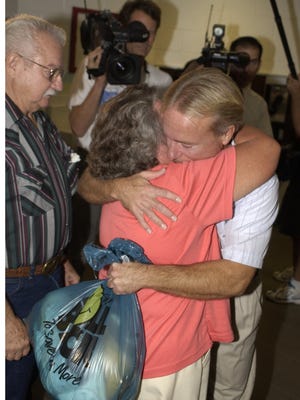 Free at last. Mary and Gary Dedge greet their son, Wilton, at the Brevard County Jail in 2004. Wilton Dedge was exonerated  after spending more than 22 years in prison for a rape that DNA evidence has now shown he did not commit.-