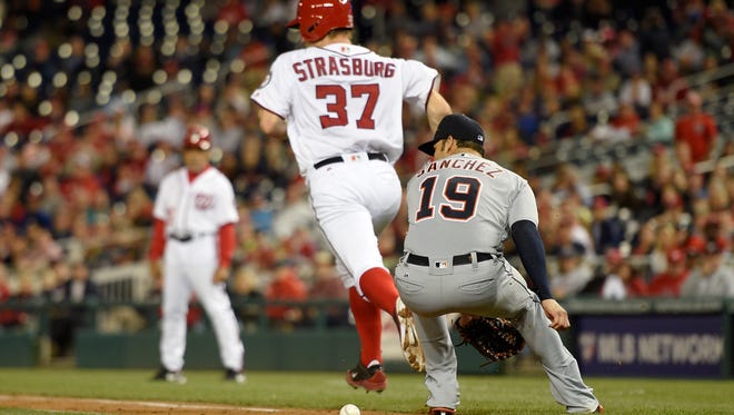 Tigers pitcher Anibal Sanchez (19) commits a fielding error on a bunt by Nationals pitcher Stephen Strasburg (37) during the seventh inning of the Tigers' 5-4 loss Monday in Washington.