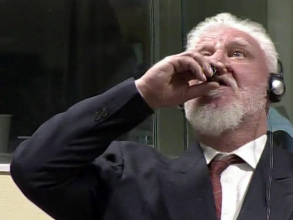 In this photo provided by the ICTY on Nov. 29, 2017, Slobodan Praljak brings what is believed a bottle to his lips, during a Yugoslav War Crimes Tribunal in The Hague, Netherlands. Praljak yelled, 