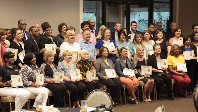 Golden Apple Award winners pose with their certificates at the Jackson Chamber’s quarterly breakfast Friday morning at the Jackson Country Club.