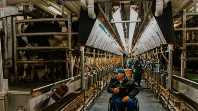 Nonagenarian Edsel Weigert marvels at the equipment in the milking parlor during a longed for visit to Vir-Clar Farms.