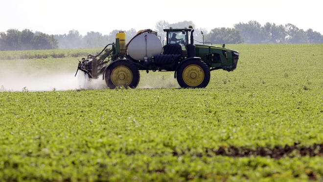 A farmer sprays a soybean field, in Granger, Iowa. The United States is by far the world's largest grower of biotech crops, planting 173 million acres in 2013