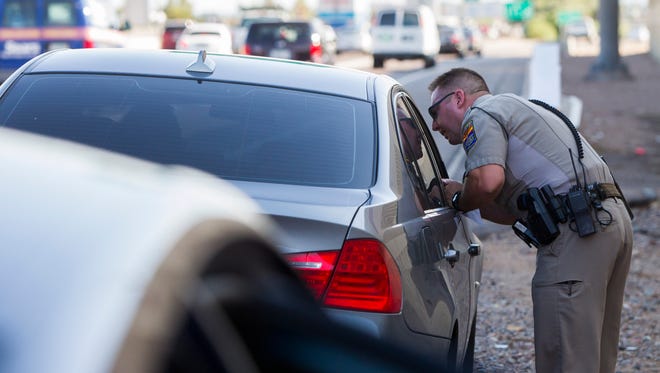 Arizona Department of Public Safety Trooper Robert Olshaskie makes a traffic stop on Interstate 17 on Friday, July 1, 2016, in Phoenix.