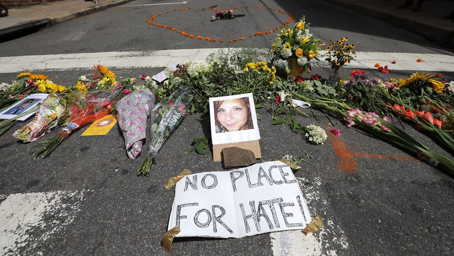 CHARLOTTESVILLE, VA - AUGUST 13: Flowers surround a photo of 32-year-old Heather Heyer, who was killed when a car plowed into a crowd of people protesting against the white supremacist Unite the Right rally, August 13, 2017 in Charlottesville, Virginia.