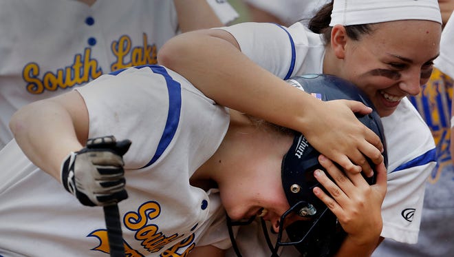 South Lake's Jessica Duncan is hugged by teammate Toni Ruthenberg after hitting a 2-run home run during first-inning action against Detroit Osborn in the Division 2 girls softball district finals, Friday, May 29, 2015.