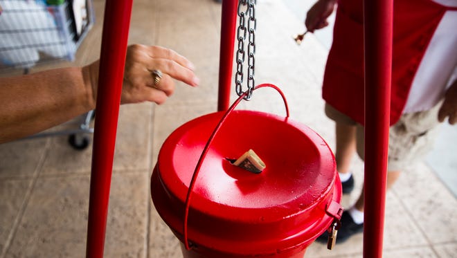 David Deciantis, a Salvation Army bell ringer, rings his bell as a Publix shopper adds money to the bucket on Monday, Nov. 28, 2016, at Publix at Kings Lake Square in East Naples. The Red Kettle Christmas Campaign provides food, clothing and toys to families in need during the holiday season.