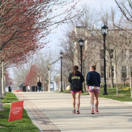 Students walk at DePauw University in Greencastle, Ind., Wednesday, April 18, 2018. On Tuesday, April 17, actress Jenna Fischer was speaking on campus when a protest broke out in reaction to recent racial slurs and hateful messages found on and near campus. Students protested again Wednesday morning during a university news conference addressing the issue. 